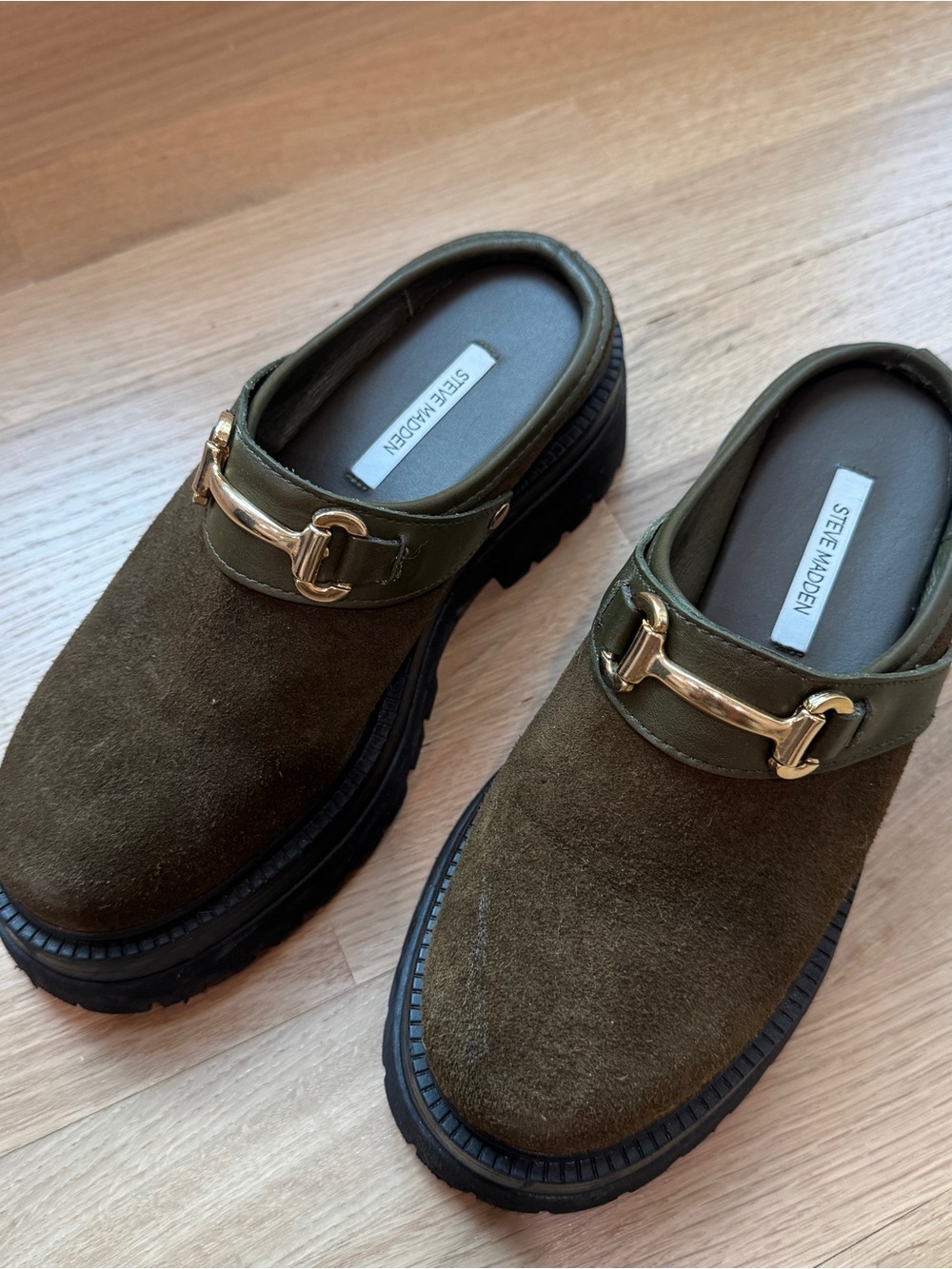 Steve Madden Erba olive suede mules featuring a gold-toned horsebit detail
